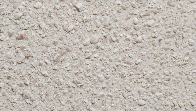 Crushed shell beach texture in soft cream and pink tones for coastal backgrounds