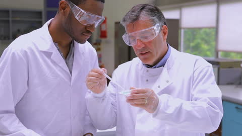 Scientists Analyzing Samples Wearing Protective Gear in Modern Lab
