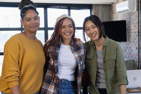 Diverse Female Coworkers Collaborating in Modern Loft Office