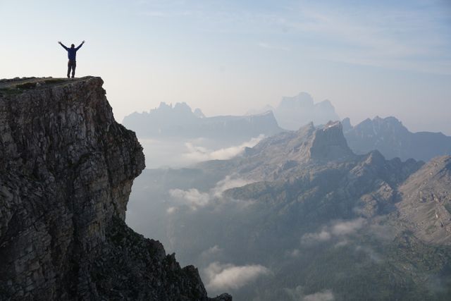 Silhouette Photo of a Man Standing on the Edge of the Mountain - Download Free Stock Photos Pikwizard.com