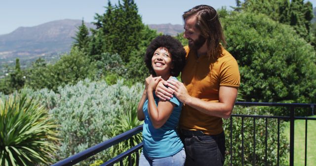 Biracial couple embracing each other and enjoying the view while standing in the balcony at home. staying at home in self isolation in quarantine lockdown
