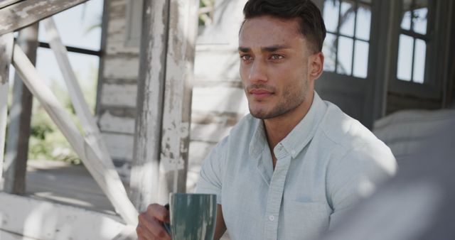 Man Relaxing Outdoors with Coffee on Rustic Porch - Download Free Stock Images Pikwizard.com