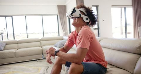 Young man engaging in virtual reality gaming at home