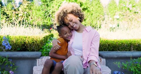 Mother and son embracing in garden serenity