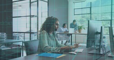 Headset Support Specialist Working at Desktop with Data Overlay in open-plan Modern Office