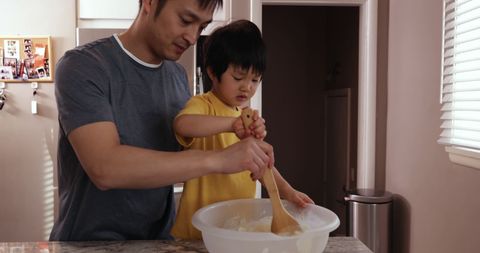 Father and Son Bonding over Baking in Cozy Kitchen