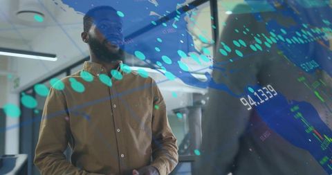 Black professional presenting data with digital analytics overlay in modern glass office