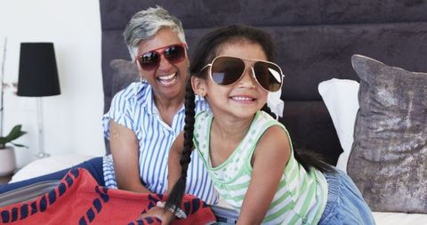 Joyful Moments: Grandma and Girl Bonding with Sunglasses