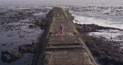 Woman Running on Seaside Promenade Workout Session