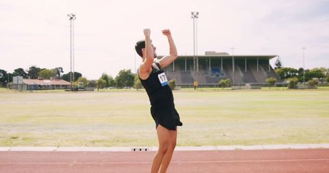 Joyful Runner Celebrating Victory on Outdoor Track