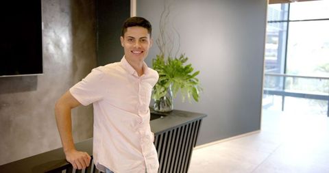 Smiling professional man in modern office lobby environment