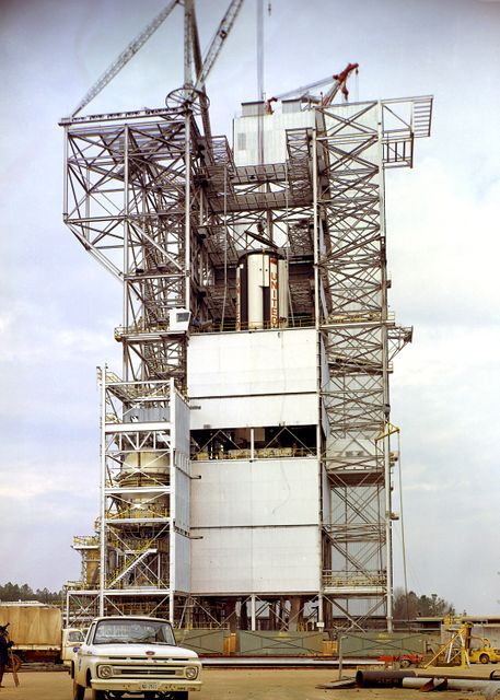 Marshall Space Flight Center (MSFC) workers lower S-IB-200D, a dynamic test version of the Saturn IB launch vehicle's first stage (S-IB stage), into the Center's Dynamic Test Stand on January 12, 1965. Test Laboratory persornel assembled a complete Saturn IB to test the structural soundness of the launch vehicle. Developed by the MSFC as an interim vehicle in MSFC's "building block" approach to Saturn rocket development, the Saturn IB utilized Saturn I technology to further develop and refine large boosters and the Apollo spacecraft capabilities required for the manned lunar missions. 