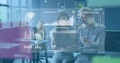Two coworkers reviewing data on laptop with augmented hud charts in open-plan office