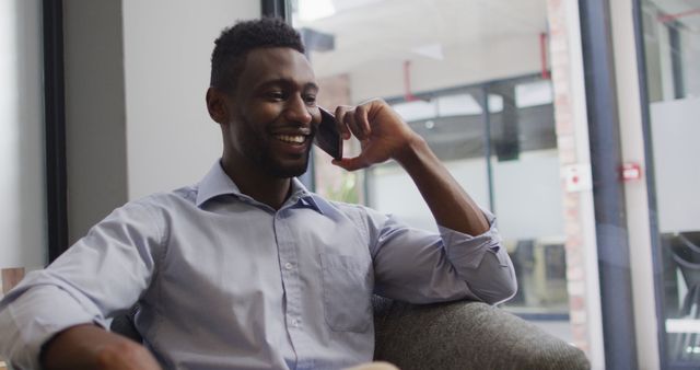 Businessman Enjoying Phone Call in Modern Office - Download Free Stock Images Pikwizard.com