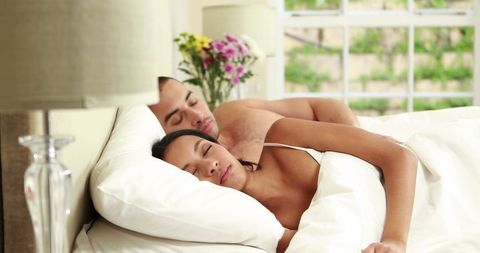 Peaceful Couple Sleeping in Bright Bedroom
