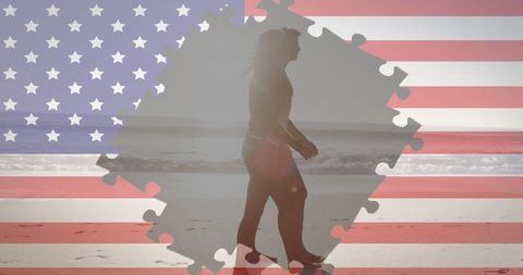 Silhouette of Woman Walking on Beach Overlaid with American Flag