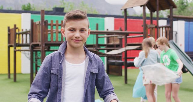 Smiling Boy in Playground with Children Playing in Background - Download Free Stock Images Pikwizard.com