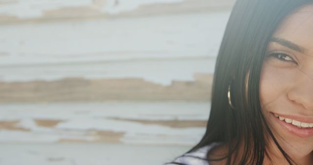 Smiling Woman with Long Dark Hair Against Weathered Wooden Wall - Download Free Stock Images Pikwizard.com