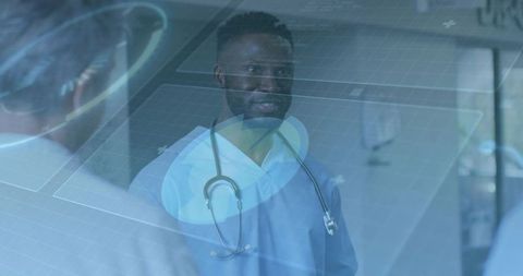 Clinician consulting with holographic interface in hospital corridor for telemedicine collaboration