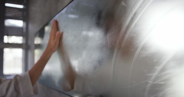 Person Wiping Steam from Bathroom Mirror - Download Free Stock Images Pikwizard.com