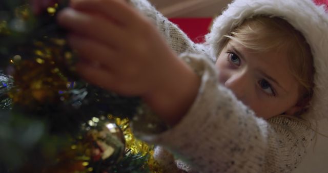 Child Decorating Christmas Tree Wearing Santa Hat - Download Free Stock Images Pikwizard.com