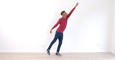 Young Man Joyfully Dancing Against White Background - Download Free Stock Images Pikwizard.com