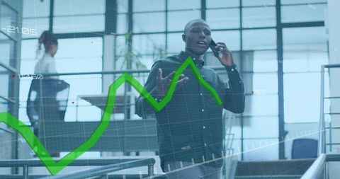 Professional Talking on Phone and Gesturing in Modern Office with Green Data Visualization Overlay