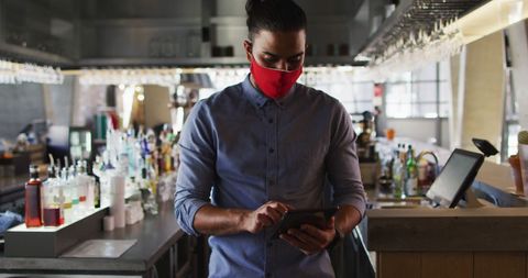 Cafe Owner in Mask Using Tablet in Stylish Urban Setting - Download Free Stock Images Pikwizard.com