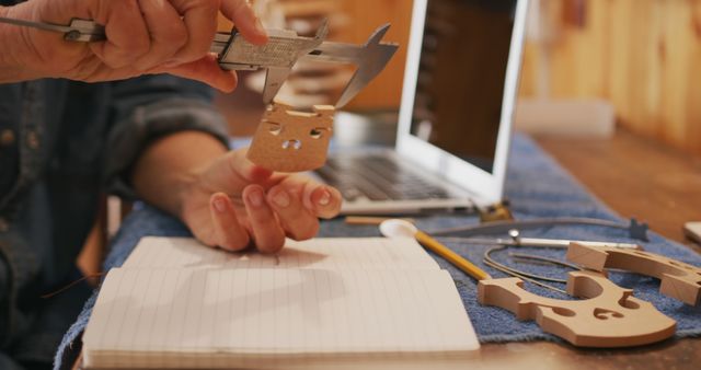 Close-up of Woodworker Measuring Piece Near Laptop and Notepad - Download Free Stock Images Pikwizard.com