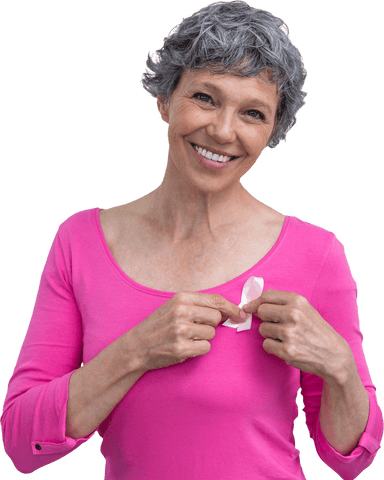 Smiling senior woman with breast cancer awareness ribbon on pink top