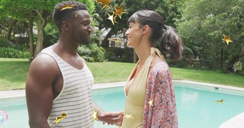 Romantic Couple Holding Hands by Backyard Pool with Golden Star Overlays
