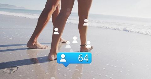 Couple Strolling on Beach with Social Media Symbols