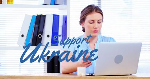 Businesswoman showing support for ukraine using laptop