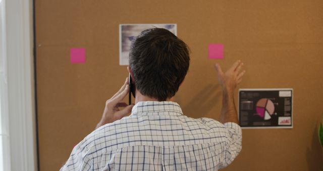 Professional Man Discussing Project on Phone in Office - Download Free Stock Images Pikwizard.com