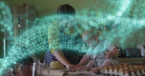 Kneading dough with toddler on kitchen counter, teal particle swirl, home baking moment