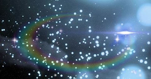 Sweeping multicolor flare arc crossing glittering star field with blue bokeh lens flare