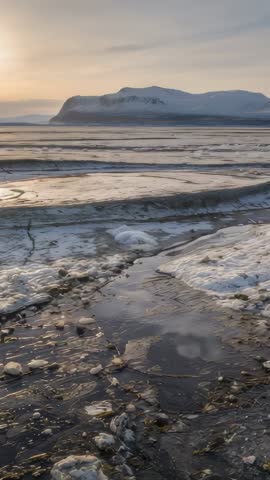 Vertical Arctic Twilight Video Showing Meltwater Channels on Icy Tidal Flats