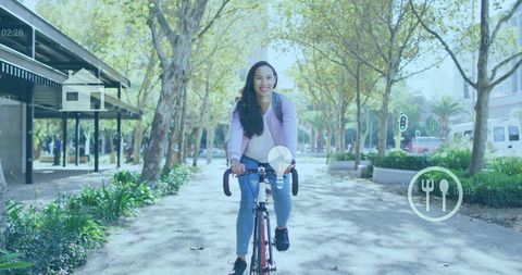 Woman Biking with Digital Icons in Urban Park Setting - Download Free Stock Images Pikwizard.com