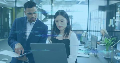 Business Professionals Collaborating with Laptop in Open Office