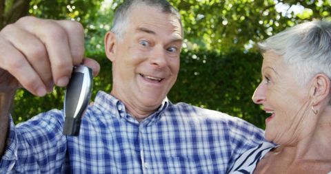 Joyful Senior Couple Celebrating New Car Gift
