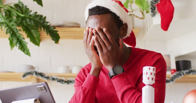 Man in Santa Hat Feeling Stressed During Remote Work - Download Free Stock Images Pikwizard.com