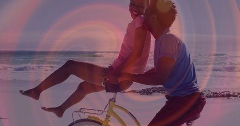 Romantic couple enjoying beachfront bicycle ride embracing adventure and love