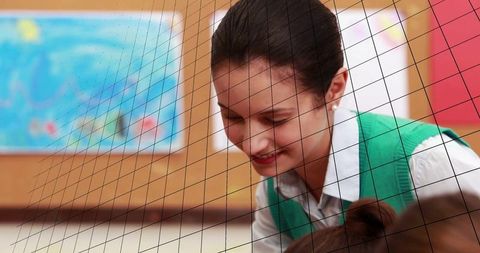 Female teacher assisting students in classroom setting