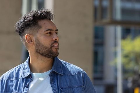 African american man looking left in denim jacket and white tee urban lifestyle portrait