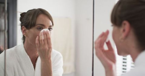 Middle-Aged Woman Applying Skincare Reflective Moment - Download Free Stock Images Pikwizard.com