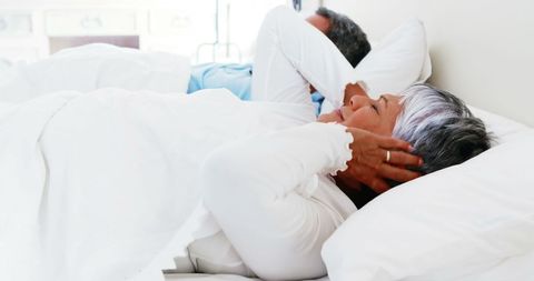 Senior Woman Disturbs by Partner's Snoring in Bedroom