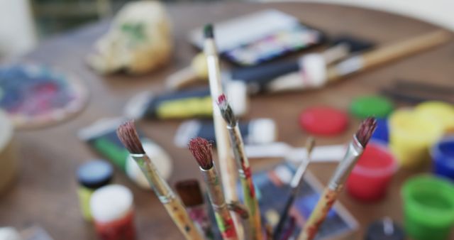 Close-Up of Paintbrushes on Artistic Workspace Table - Download Free Stock Images Pikwizard.com