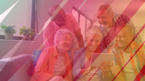 Diverse Group of Seniors Using Tablet, Collaborating in Modern Room