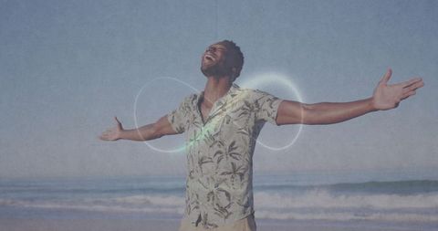 Joyful Man Embracing Coastal Breeze with Outstretched Arms