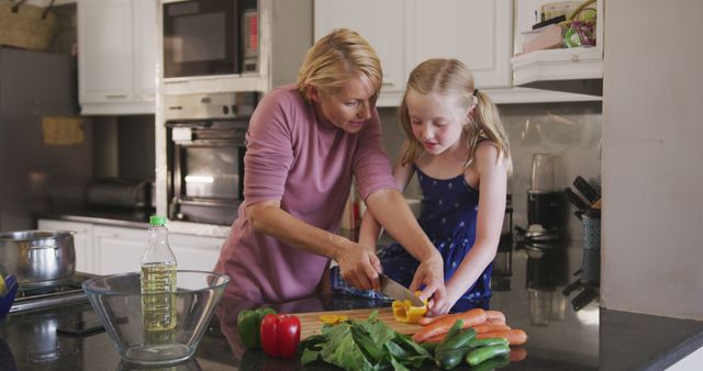 Mother and Daughter Preparing Vegetables in Kitchen Together - Download Free Stock Images Pikwizard.com